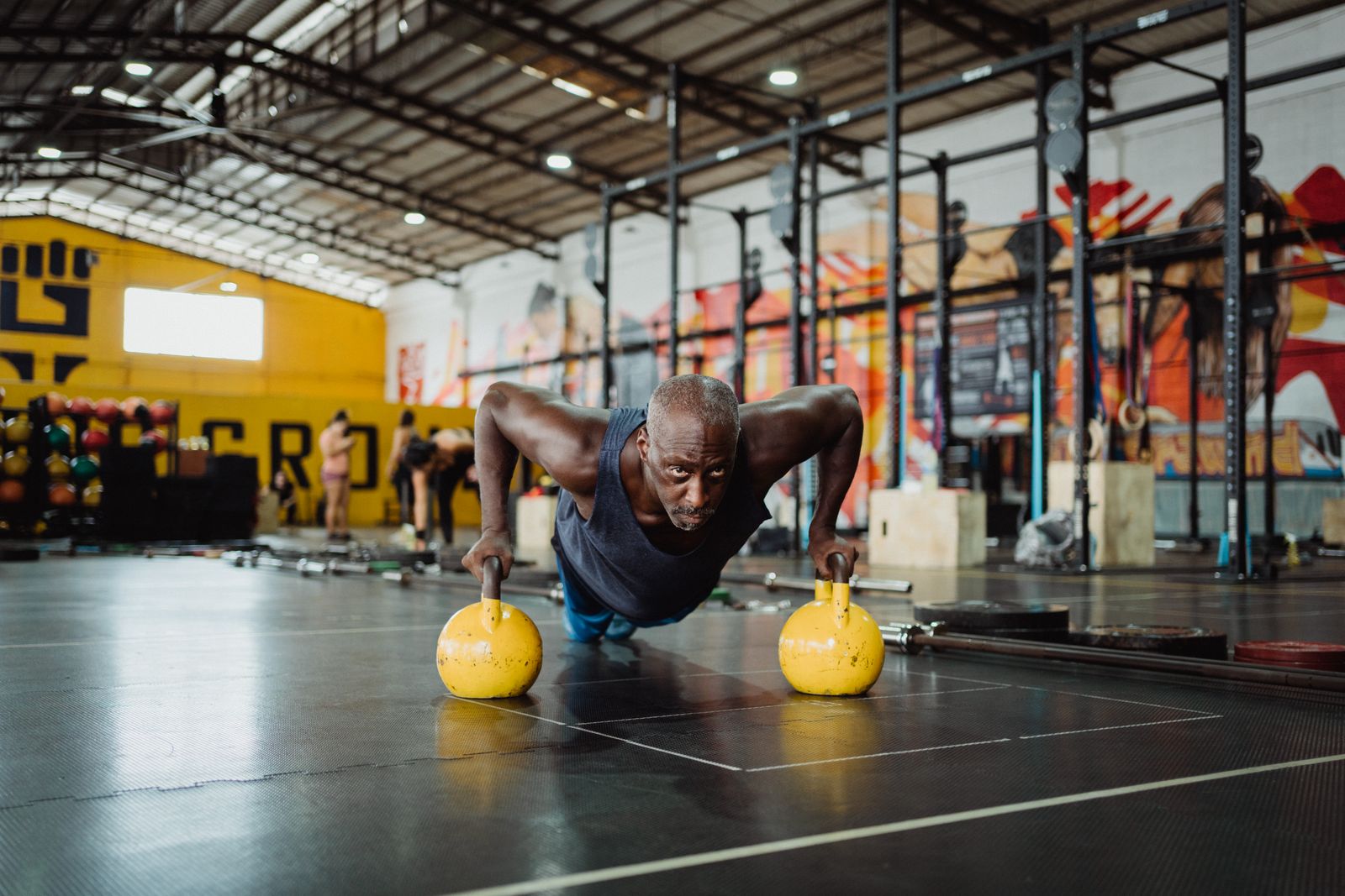 Black athlete training with kettlebells
